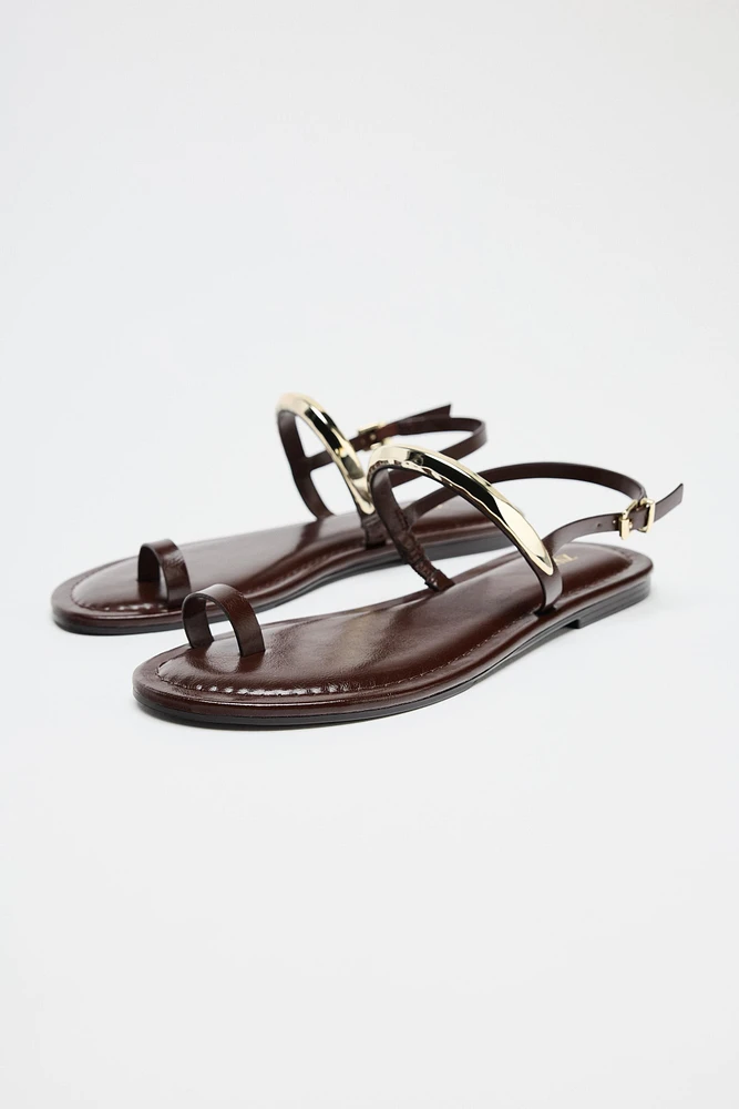 FLAT SANDALS WITH METAL APPLIQUÉ