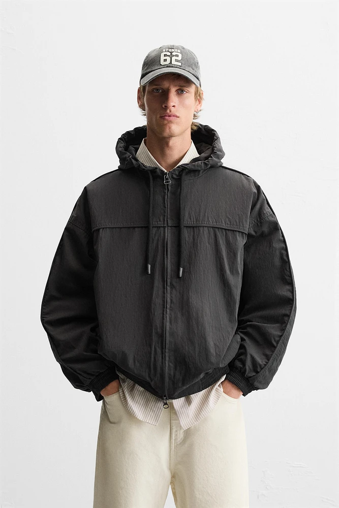 BLOUSON TECHNIQUE À CAPUCHE