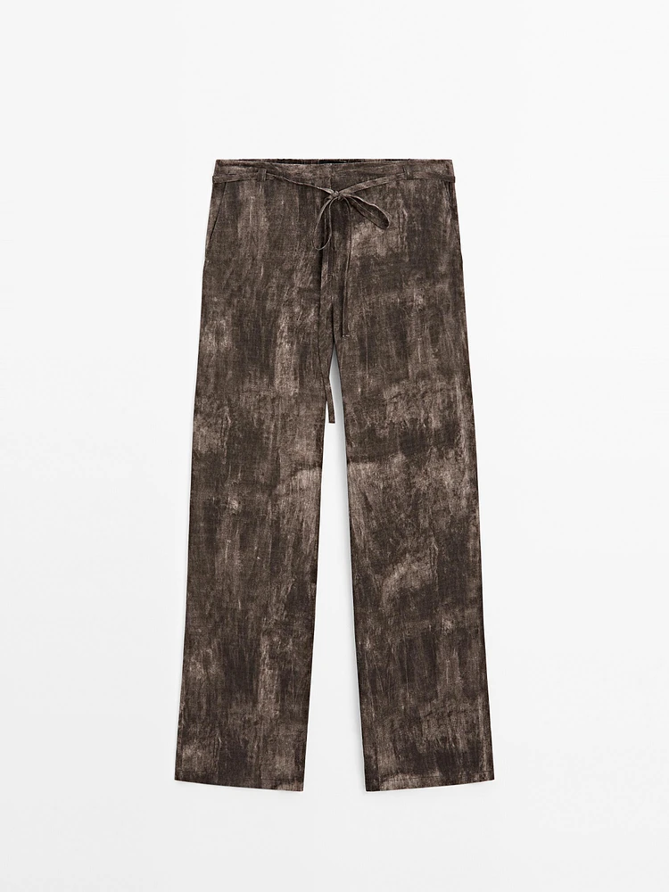 Distressed-effect flared trousers