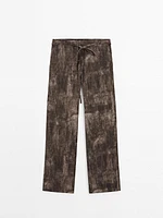 Distressed-effect flared trousers