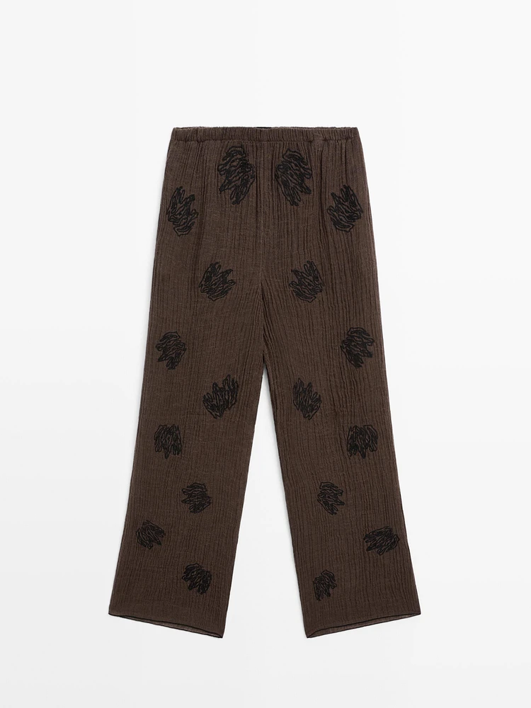 Flowing textured trousers with embroidered detail