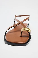 FLAT SANDALS WITH STRAPS AND METAL DETAIL