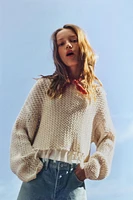 PULL EN MAILLE RÉSILLE À FRANGES