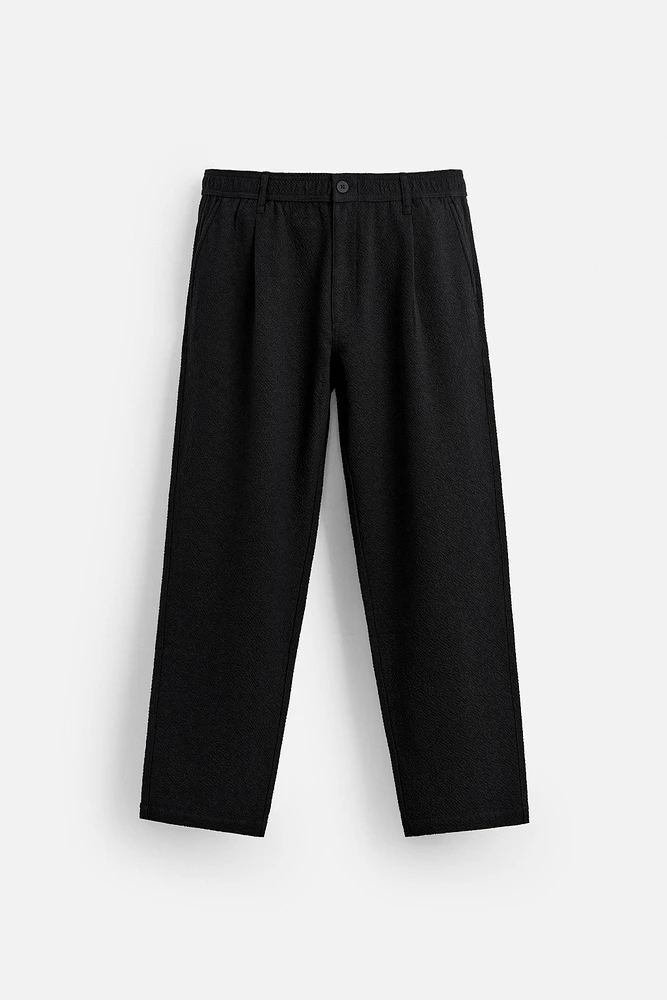 TEXTURED PLEATED PANTS