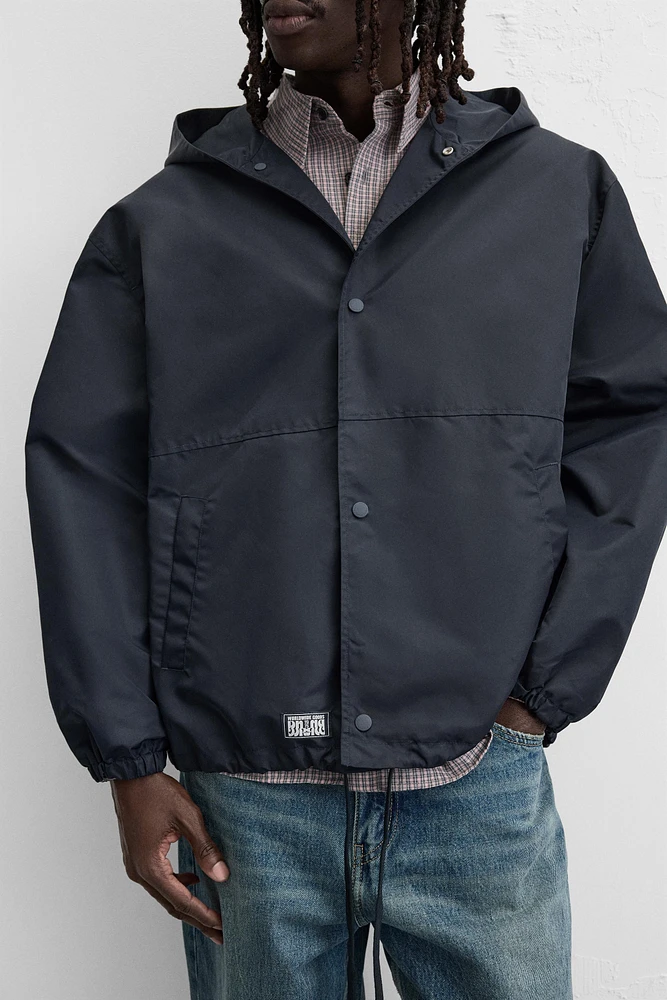 HOODED TECHNICAL JACKET