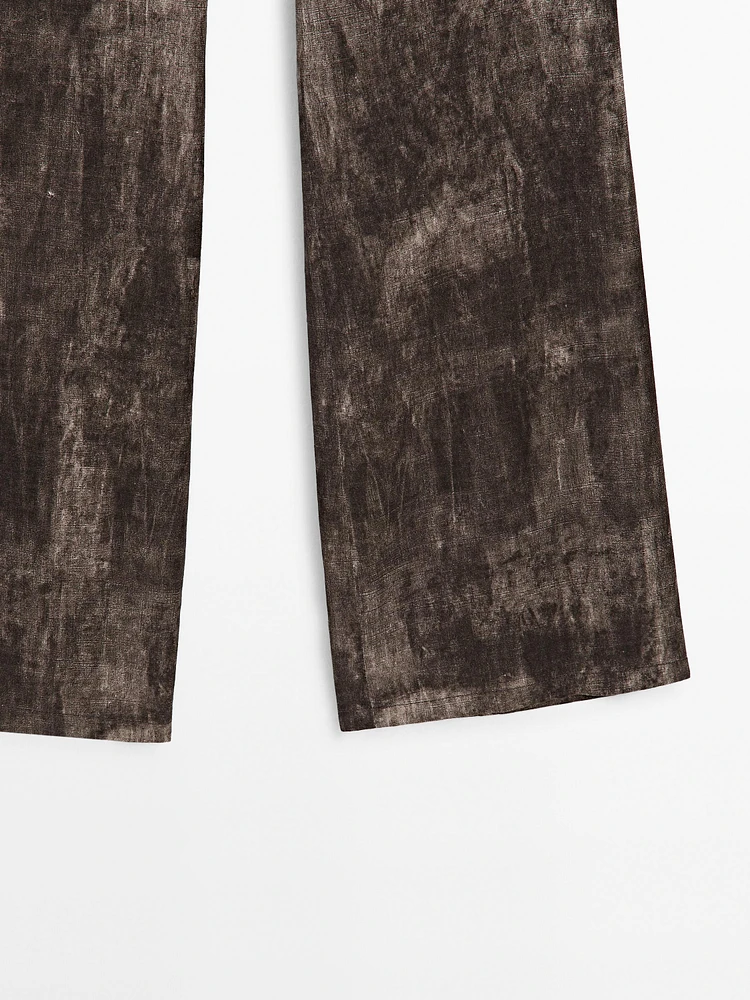 Distressed-effect flared trousers