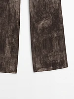 Distressed-effect flared trousers