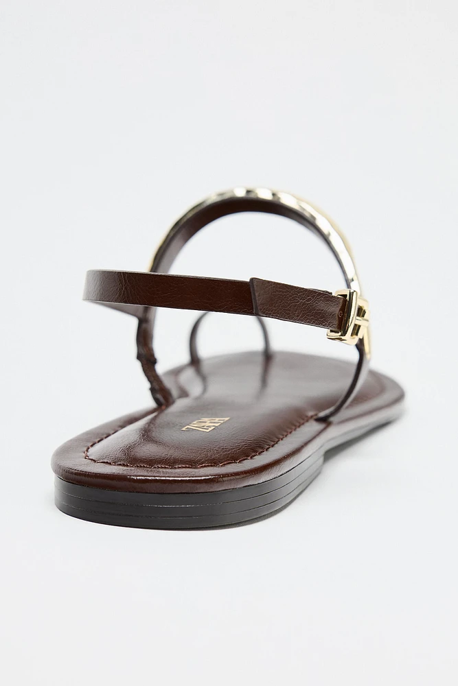 FLAT SANDALS WITH METAL APPLIQUÉ