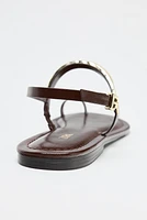 FLAT SANDALS WITH METAL APPLIQUÉ