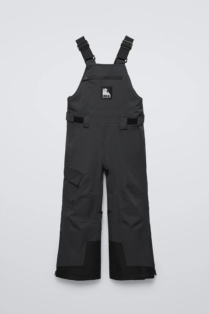 WATER REPELLENT AND WINDPROOF RECCO® SYSTEM SUSPENDERS JUMPSUIT SKI COLLECTION