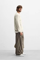 TEXTURED PLEATED PANTS