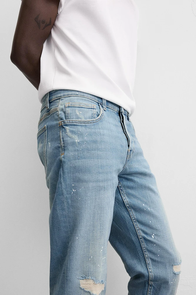 JEANS SKINNY AVEC DÉCHIRURES ET ÉCLABOUSSURES