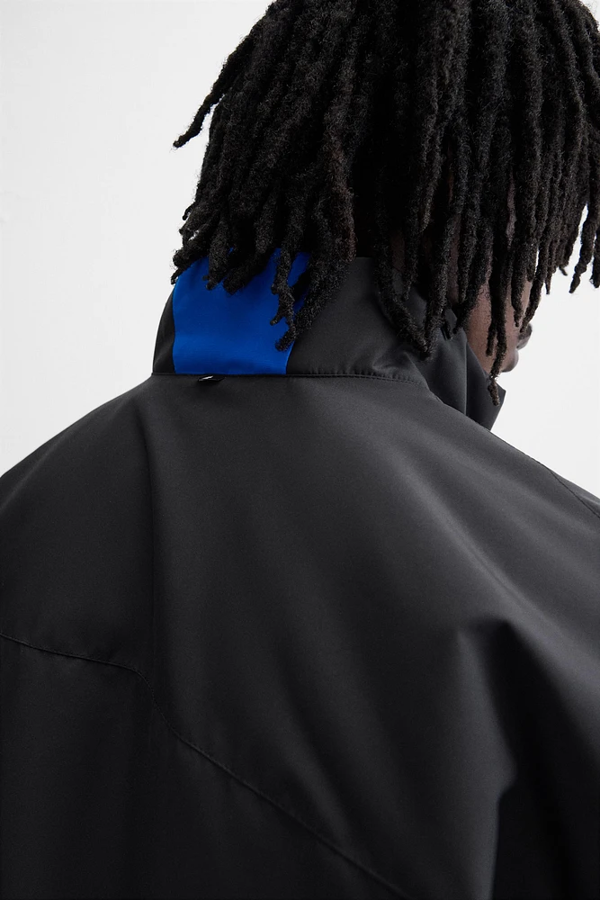 BLOUSON TECHNIQUE AVEC BLOCS DE COULEUR