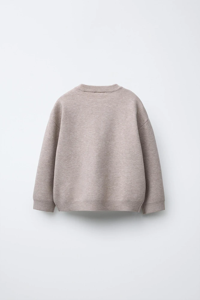 PULL EN MAILLE À POCHE