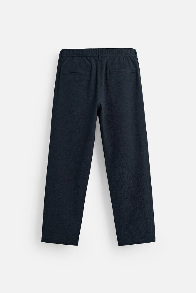 TEXTURED PLEATED PANTS
