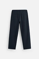 TEXTURED PLEATED PANTS