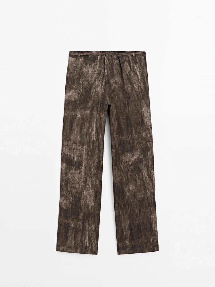 Distressed-effect flared trousers