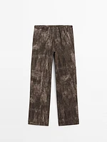 Distressed-effect flared trousers