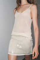MINI-JUPE EN MAILLE À SEQUINS