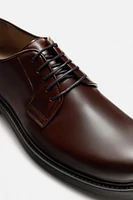 CHAUSSURES EN CUIR HABILLÉES