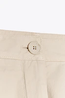 PLEATED CHINO PANTS