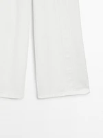 Jean wide leg taille haute avec découpes