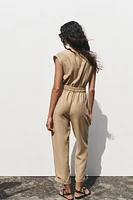 SLEEVELESS BELTED JUMPSUIT