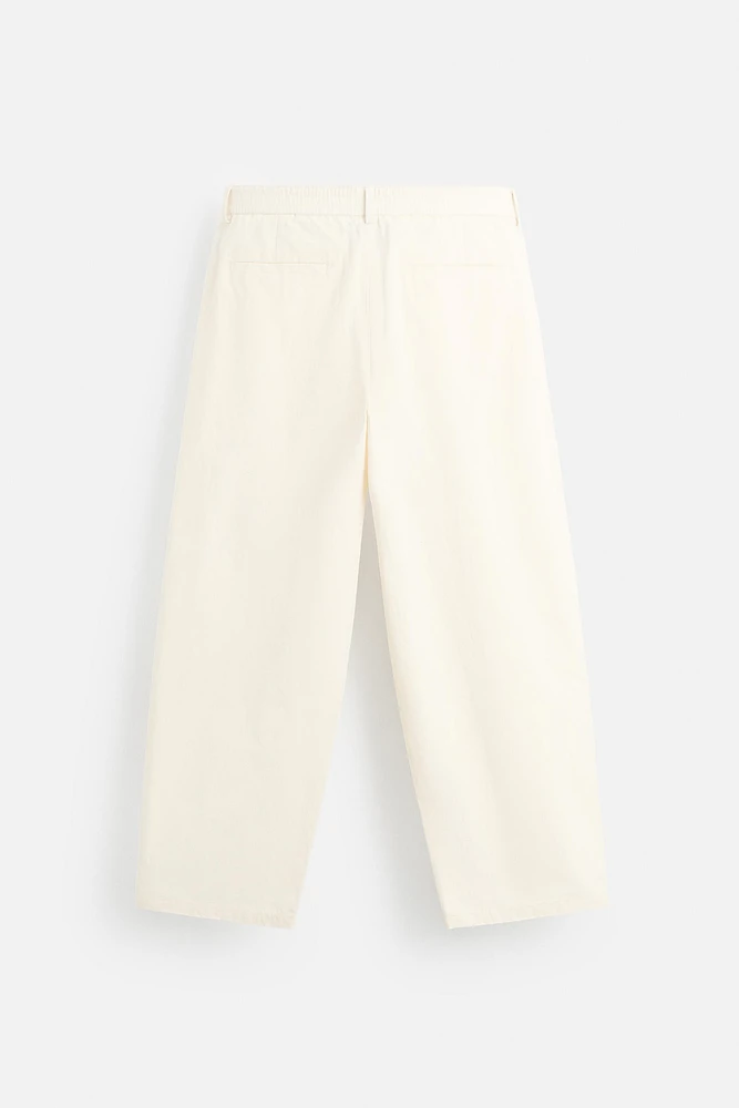 PLEATED CHINO PANTS