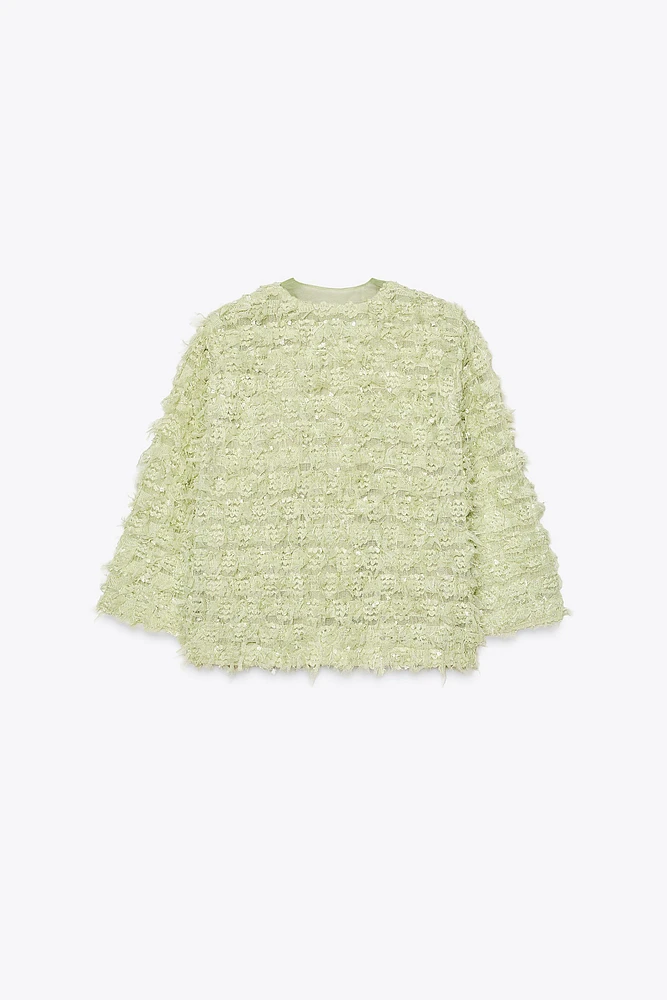 GILET EN MAILLE À FRANGES AVEC LACET ORGANZA