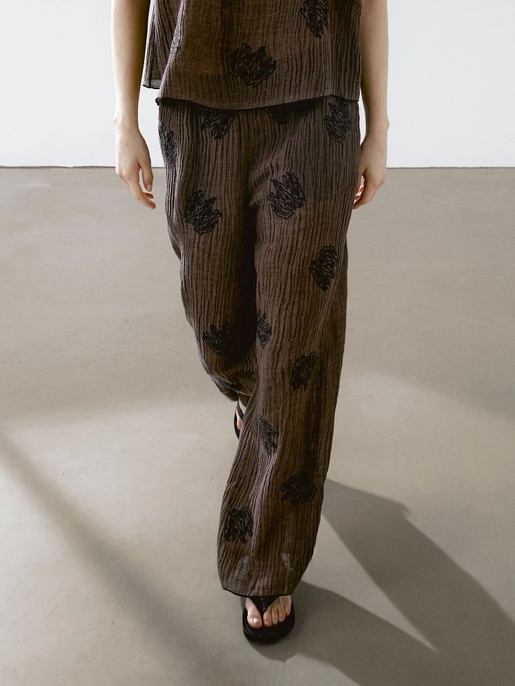 Flowing textured top with embroidered detail