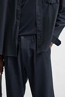 TEXTURED PLEATED PANTS