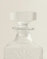 CRYSTALLINE BOTTLE WITH RAISED DESIGN