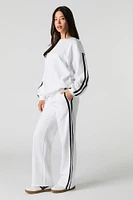 Pantalon d'entraînement en molleton avec rayures latérales