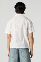 Haut boutonné avec motif de feuille brodé et oeillets