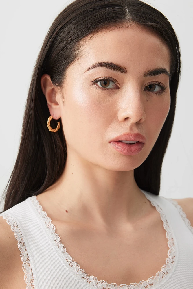 Ardene Stainless Steel Twisted Hoop Earrings in Gold