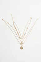 Layered Pearl & Worn Medallion Necklace