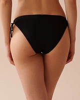 Bas de bikini brésilien noué aux hanches texturé SOLID