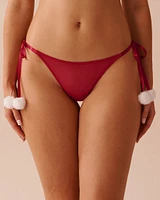 Culotte tanga en résille à pompons