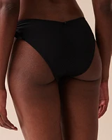 Bas de bikini brésilien coupe en V noué aux hanches texturé