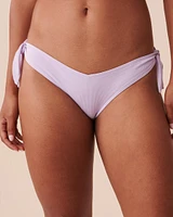 Bas de bikini brésilien coupe en V noué aux hanches texturé PASTEL