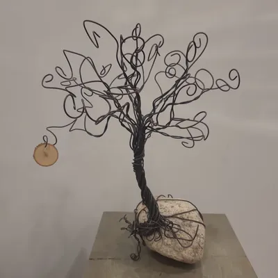 Bent into shape - small wire tree on rock