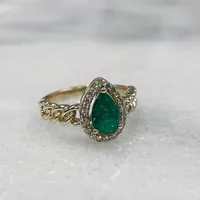 Ring with Pear Shape Emerald and .16 Carat TW of Diamonds in 10kt Yellow Gold