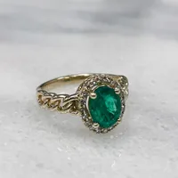 Ring with Oval Emerald and .16 Carat TW of Diamonds in 10kt Yellow Gold