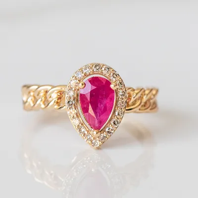 Ring with Pear Shape Ruby and .16 Carat TW of Diamonds in 10kt Yellow Gold