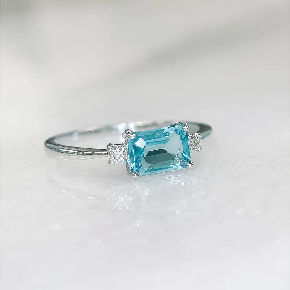 Ring with 5X7MM Emerald Cut Swiss Blue Topaz and .07 Carat TW of Diamonds in 10kt White Gold