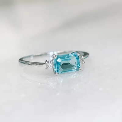 Ring with 5X7MM Emerald Cut Swiss Blue Topaz and .07 Carat TW of Diamonds in 10kt White Gold