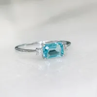 Ring with 5X7MM Emerald Cut Swiss Blue Topaz and .07 Carat TW of Diamonds in 10kt White Gold