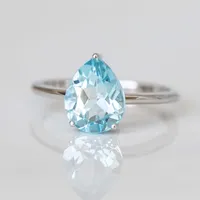 Ring with 8X10MM Pear Blue Topaz in 10kt White Gold