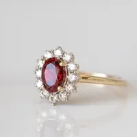 Ring with 7X5MM Oval Garnet and .40 Carat TW of Diamonds in 14kt Yellow Gold