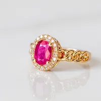 Ring with Oval Ruby and .16 Carat TW of Diamonds in 10kt Yellow Gold